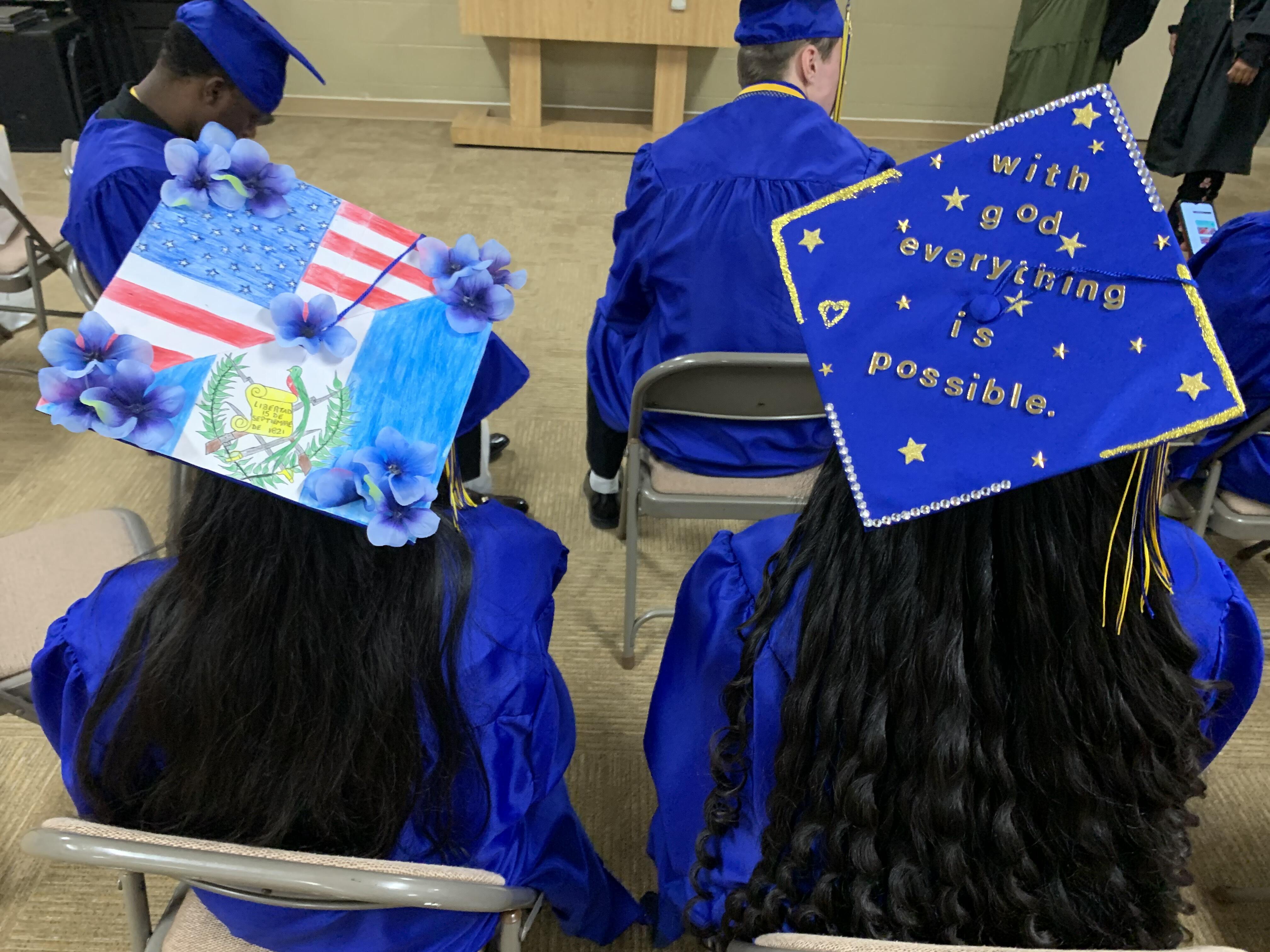 graduates showing their graduation hats